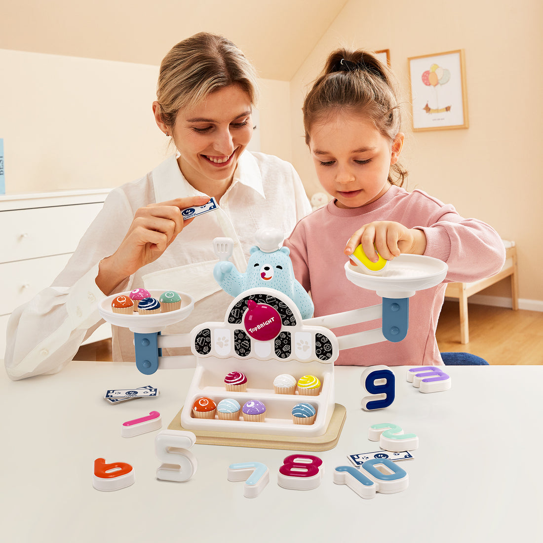 Educational balance scale toy with number cakes and pointer