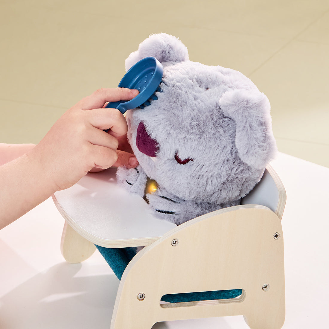 Care Pets Baby Koala plush toy sitting in baby high chair with feeding accessories for role-play caregiving.
